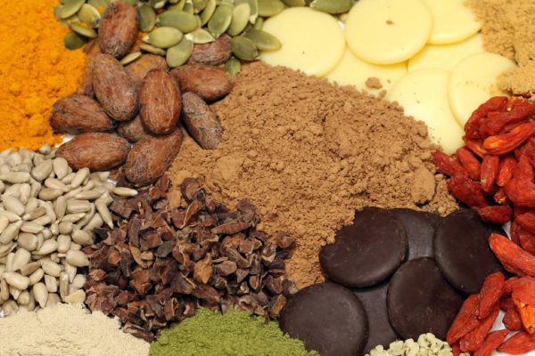 Selection of superfood powders and nuts on white background