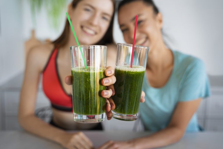two women holding superfood smoothie